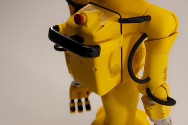 Yellow robot with black accents on a white background