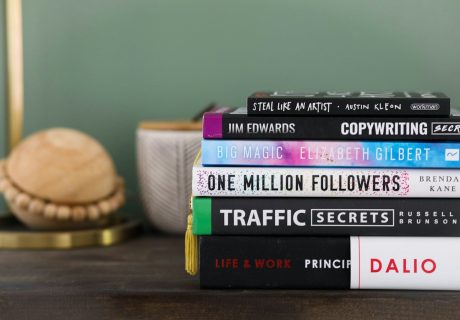 assorted books on brown wooden table