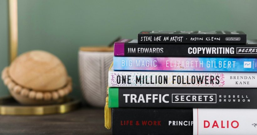 assorted books on brown wooden table