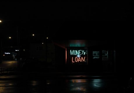 a neon sign is lit up in the dark